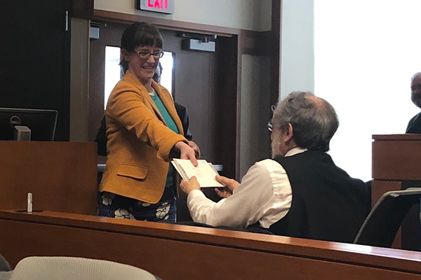 Dr. Andrea Sims presents Dr. Brian Joseph with a festschrift in his honor