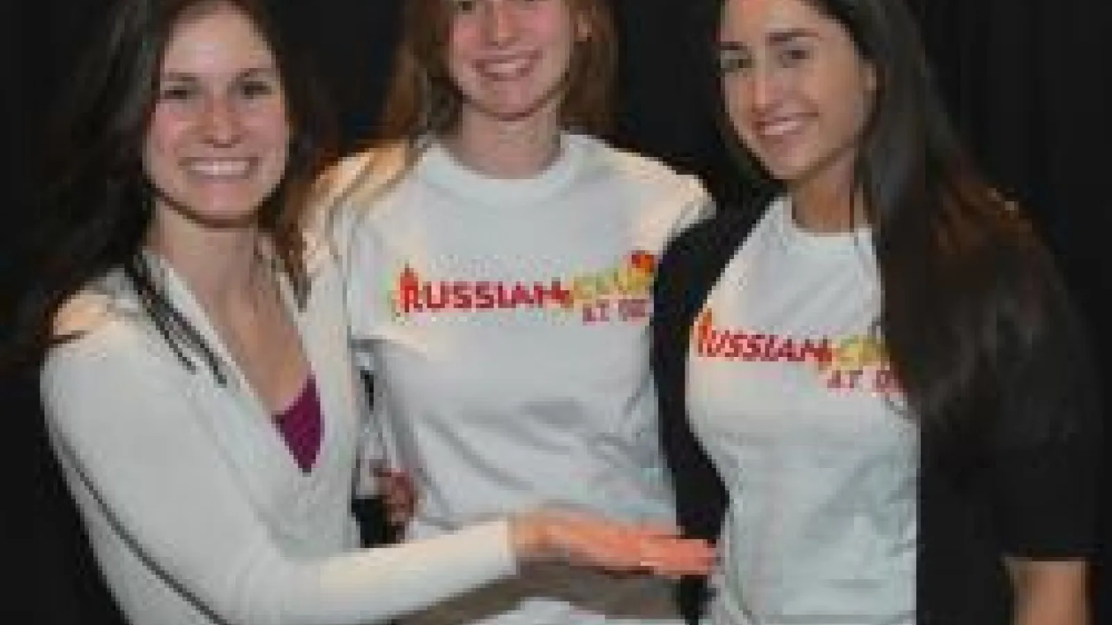 Three students together smiling for a photo