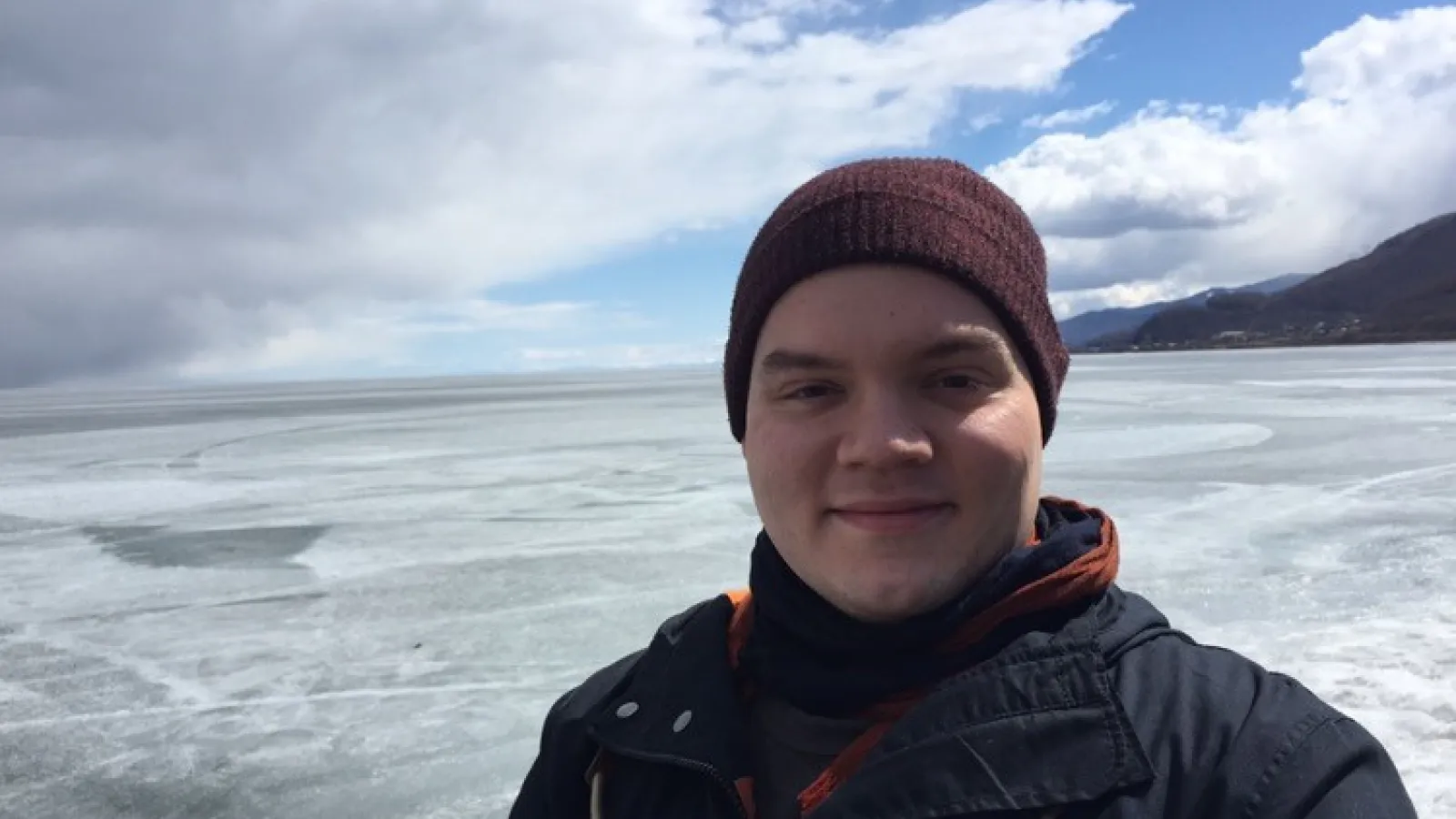 Photograph of Kenny in front of frozen Lake Baikal in Russia