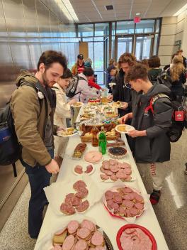 other students get food while performances begin at kapustnik