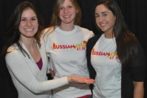 Three students together smiling for a photo