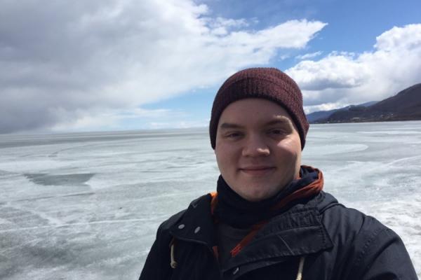 Photograph of Kenny in front of frozen Lake Baikal in Russia