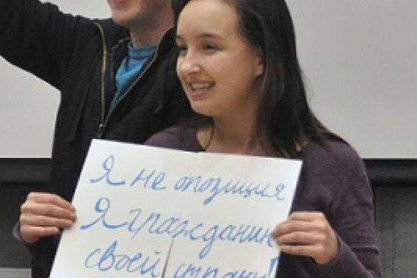 photo of a russian student holding a sign