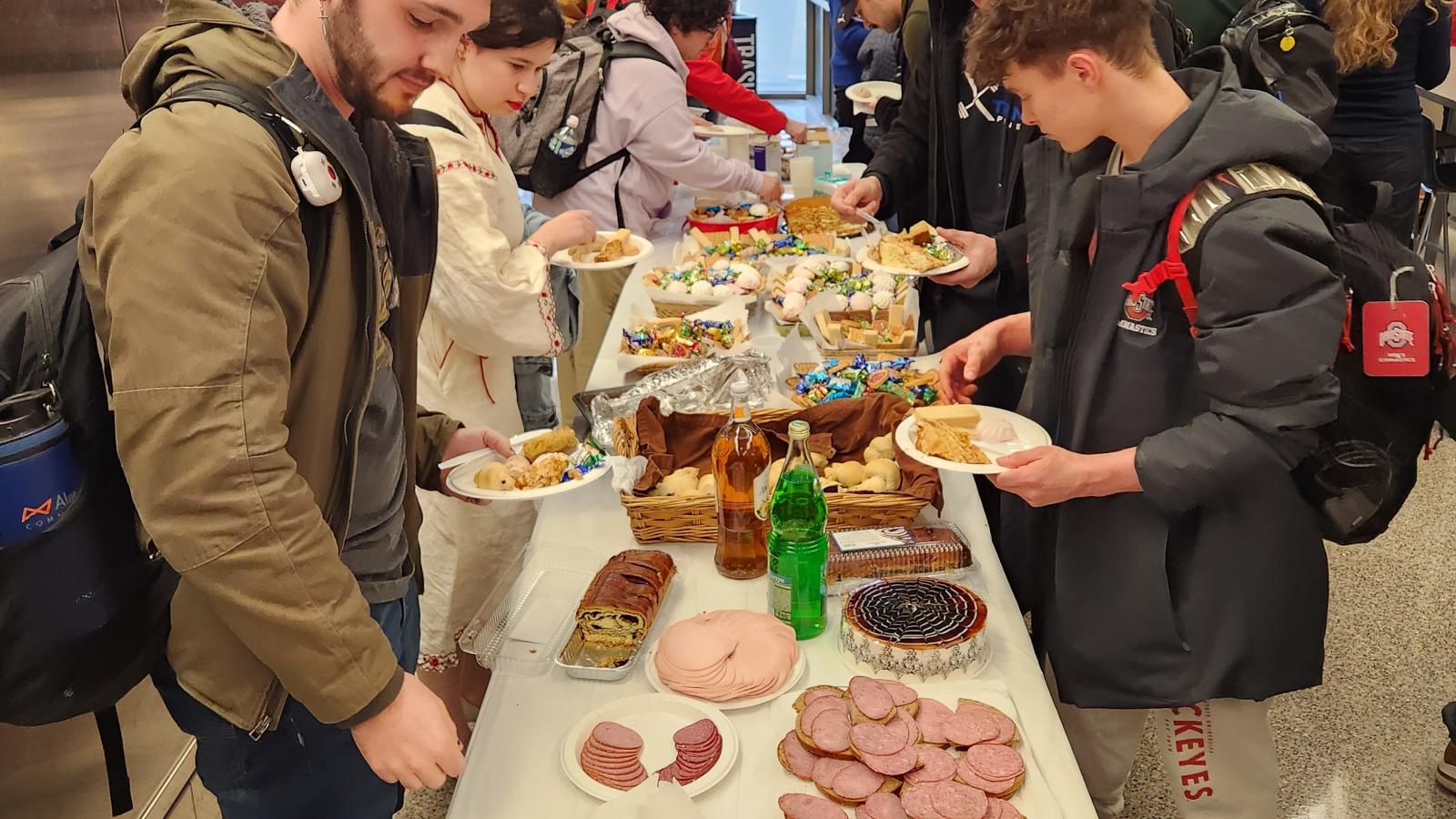 other students get food while performances begin at kapustnik