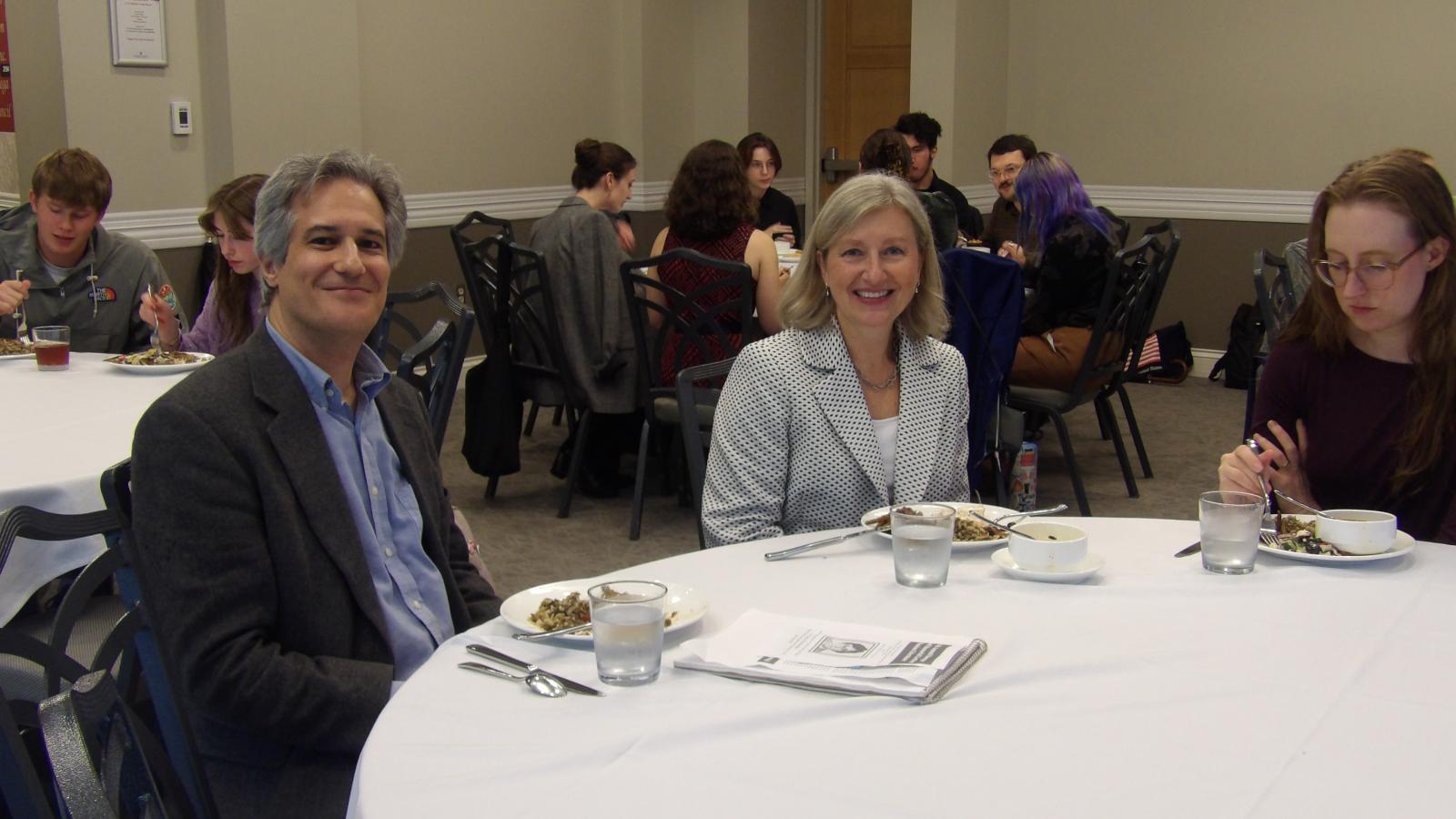 Dr. Alexander Burry and Dr. Edyta Bojanowska sitting at a table together.