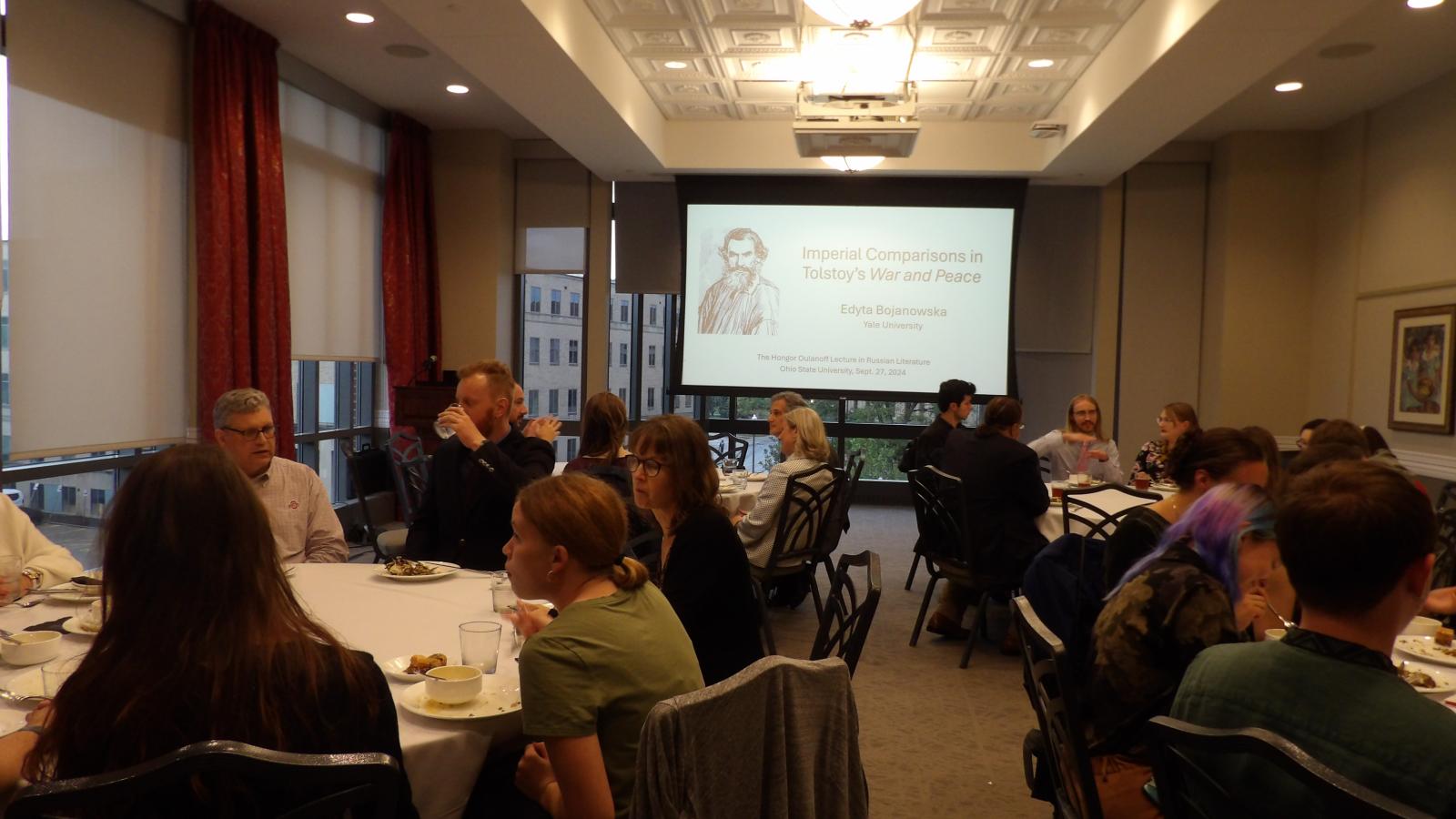 Graduate students, professors, and community members having dinner before the 2024 Oulanoff lecture.